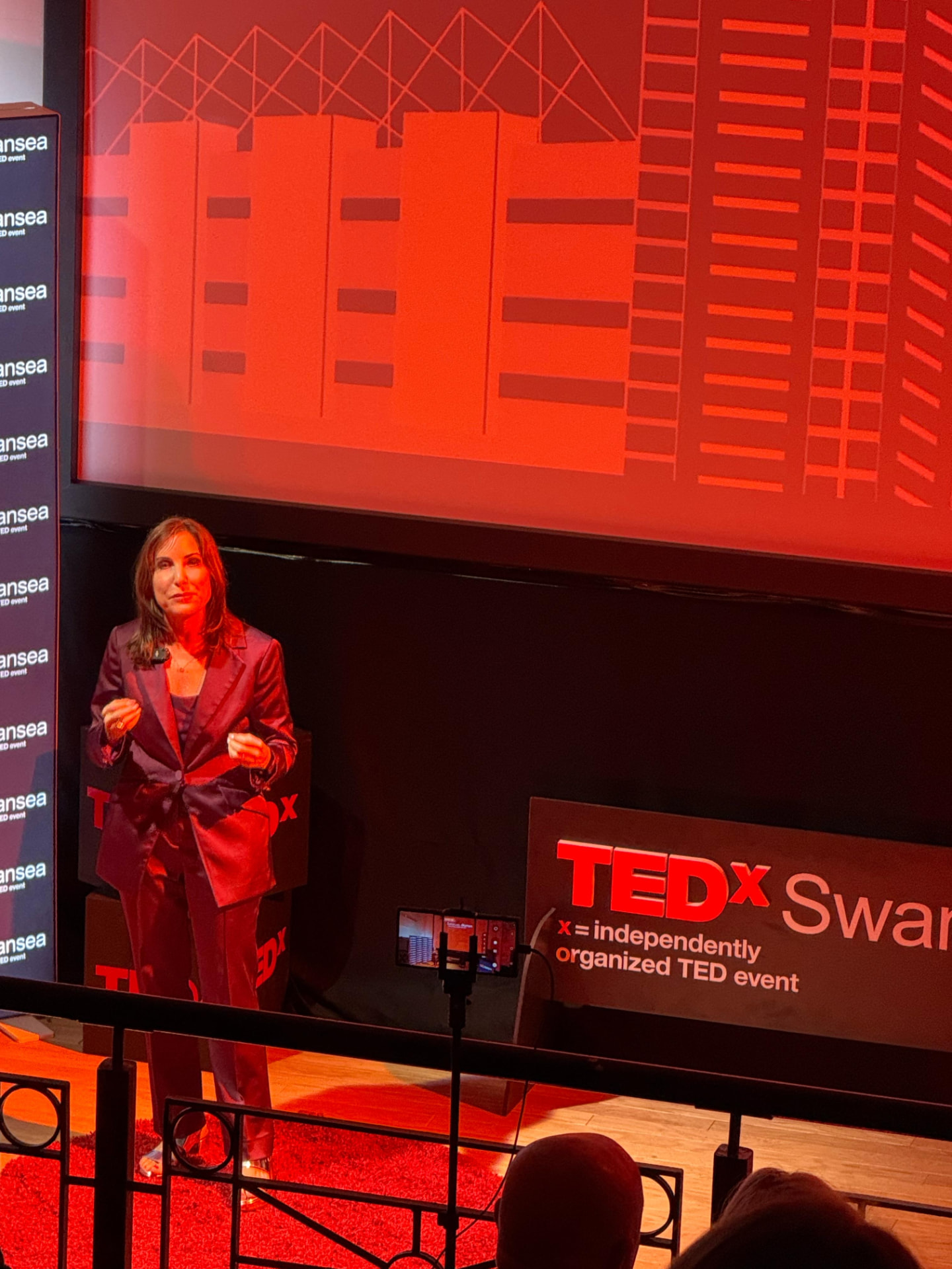 Dara Kalvort speaking on stage at TEDxSwansea Women in Swansea